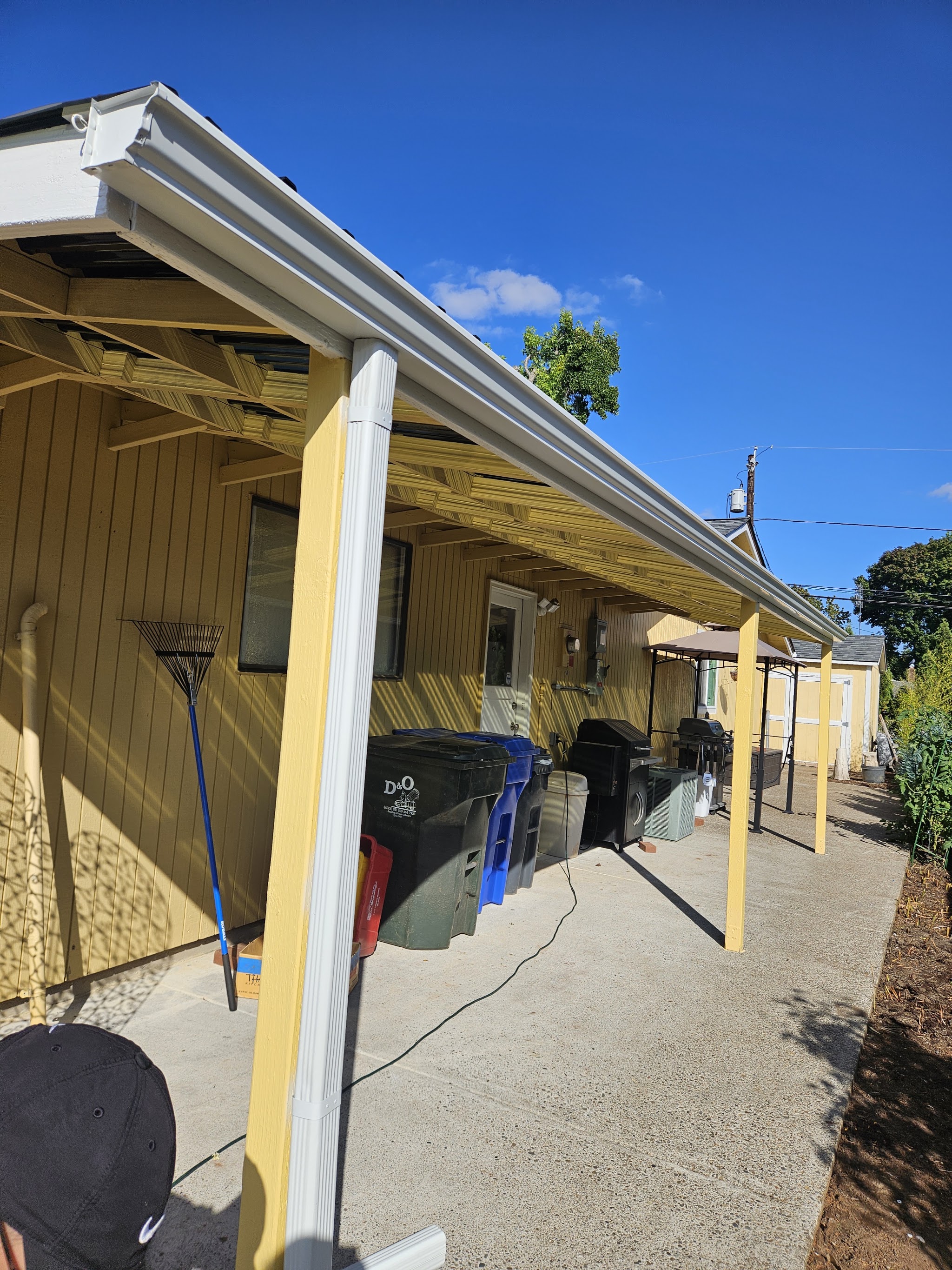 Freshly installed white gutters along a home in Salem, OR by Sparrow Gutters